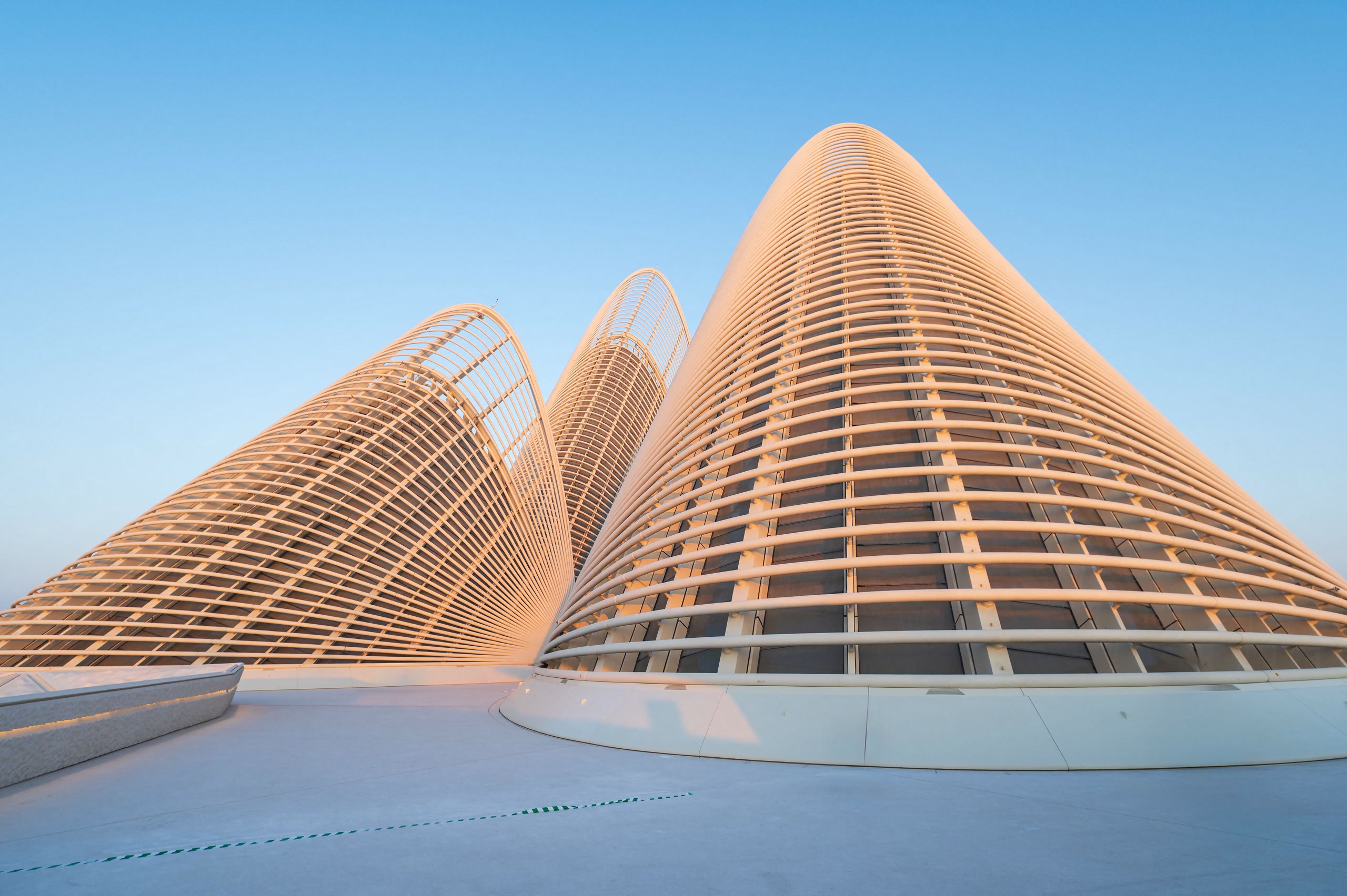 Zayed National Museum in Abu Dhabi with falcon-wing steel structures against a clear blue sky