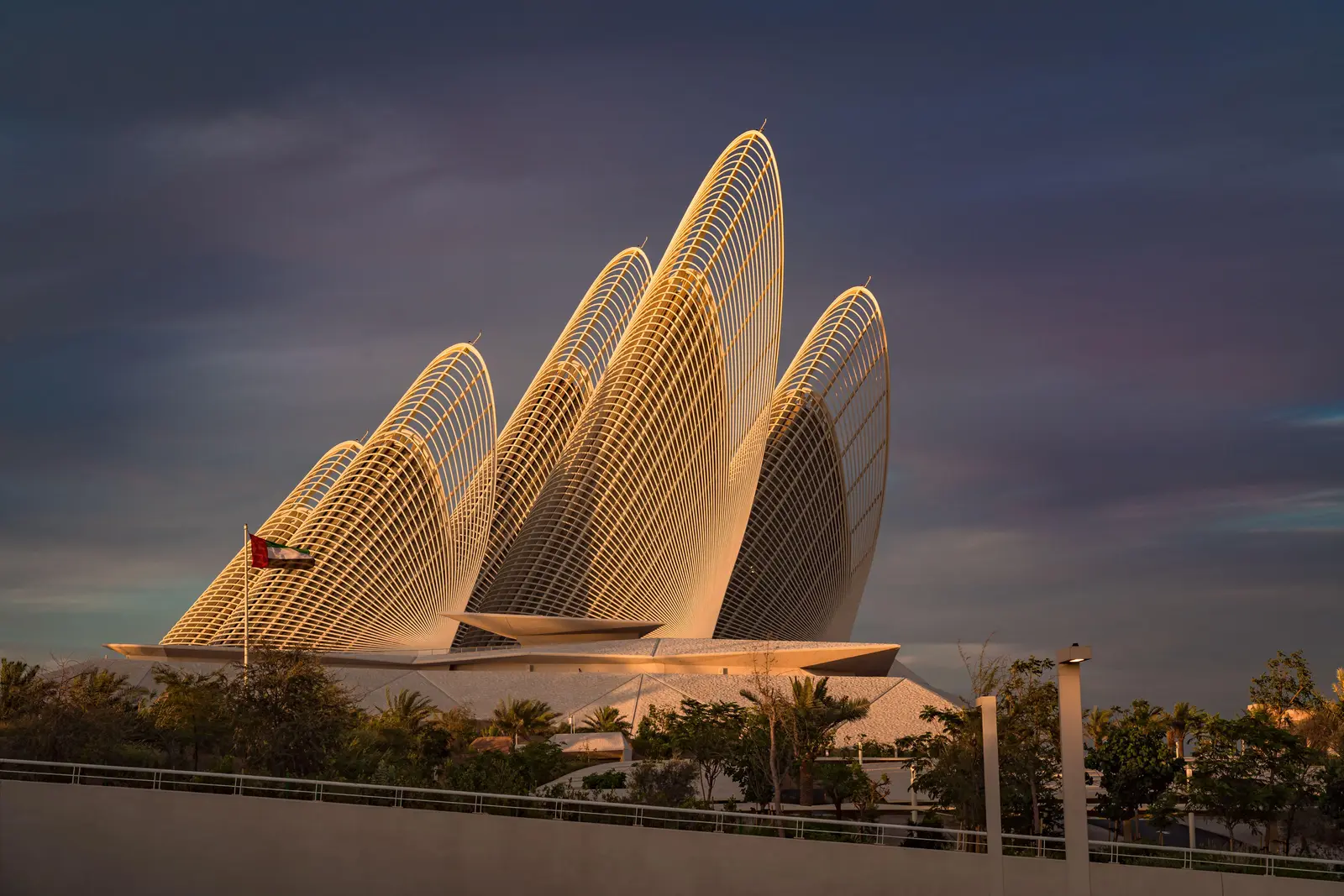 Wide exterior view of Zayed National Museum at sunset